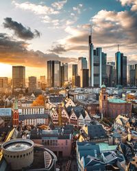 Aerial view of buildings in city during sunset