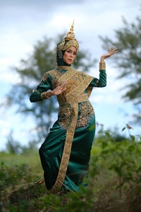 Portrait of thai woman or of buddha against sky