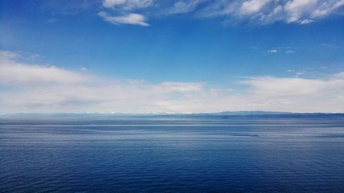 Scenic view of sea against blue sky