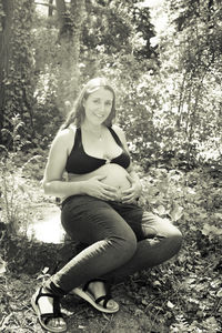 Portrait of young woman sitting on field