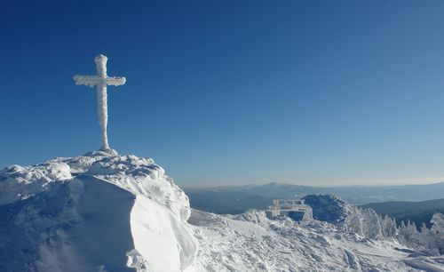 Scenic view of snowcapped mountains against clear blue sky