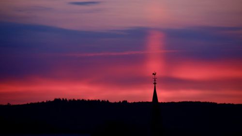 Silhouette tower against sky during sunset