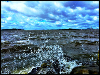 Scenic view of sea against cloudy sky