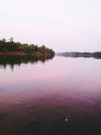 Scenic view of lake against sky at sunset