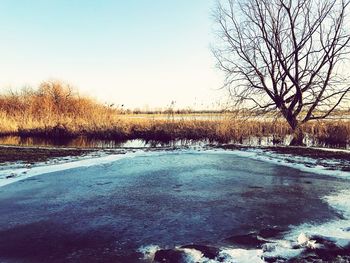 Scenic view of frozen lake against sky during winter