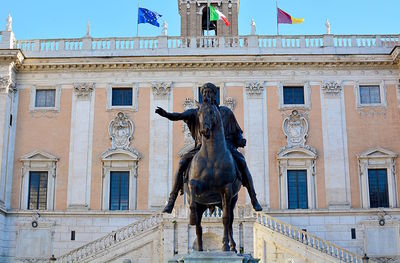 Low angle view of statue in front of building