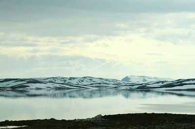 Scenic view of mountains against cloudy sky