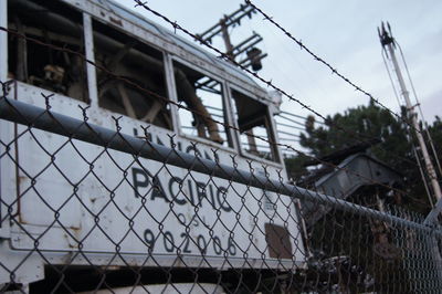 Low angle view of chainlink fence against sky