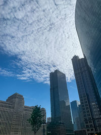 Low angle view of buildings against cloudy sky