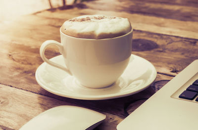 Close-up of cappuccino served on table