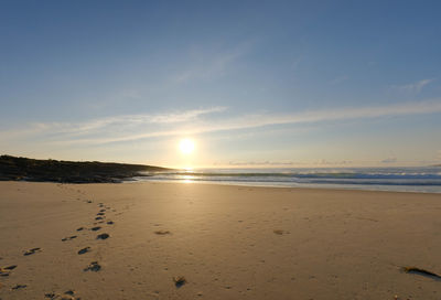 Scenic view of beach against sky during sunset