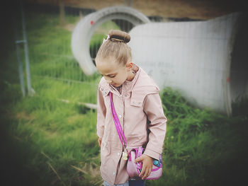 Full length of cute girl standing on field