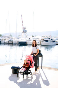 Woman sitting on boat in sea against sky