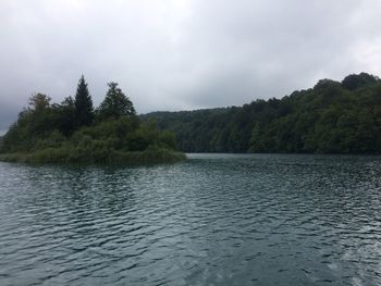 Scenic view of lake against cloudy sky