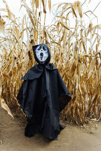 Rear view of woman standing on field