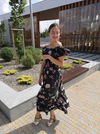 Portrait of a smiling young woman standing outdoors