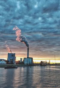 Smoke emitting from chimney against sky at sunset