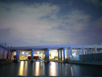 Illuminated bridge against sky at night