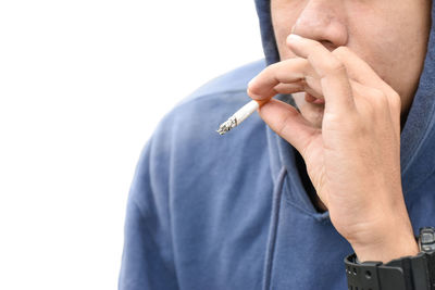 Midsection of man holding hands against white background