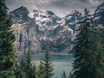 Scenic view of lake by trees against sky