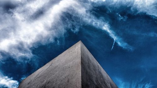 Low angle view of building against cloudy sky