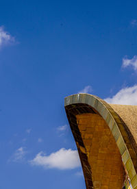 Low angle view of building against cloudy sky