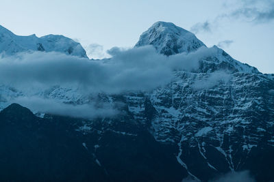 Scenic view of snow covered mountains against sky