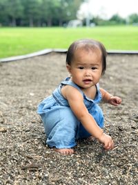 Cute baby girl on field