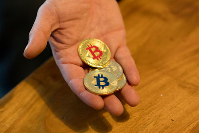 Close-up of person holding bitcoins