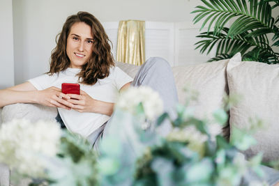 The girl is holding a cell phone in her hands.