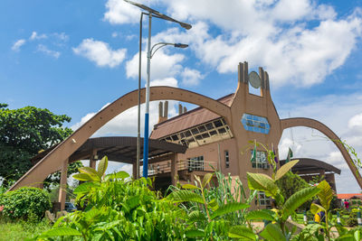 Low angle view of bridge and plants against sky