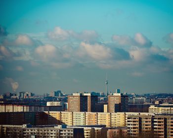 Buildings against cloudy sky