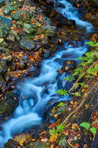 High angle view of stream flowing through rocks