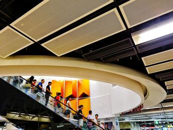 Low angle view of people in shopping mall