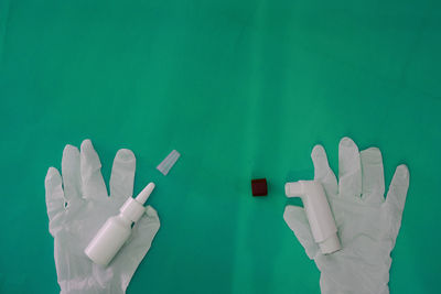 Cropped hand of person with clothespin on white background