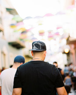 Rear view of man standing against blurred background