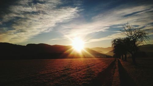 Scenic view of field against sky during sunset