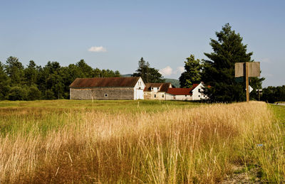 Houses on field against sky