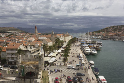 High angle view of townscape by sea against sky