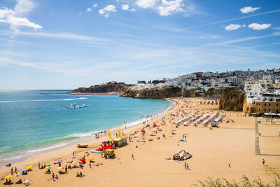 High angle view of beach by houses against blue sky