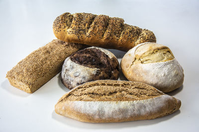 Close-up of bread on table against white background