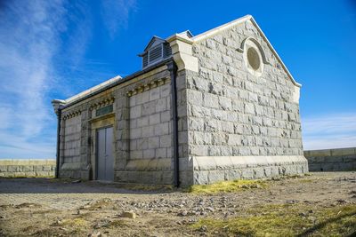 Low angle view of built structure against blue sky