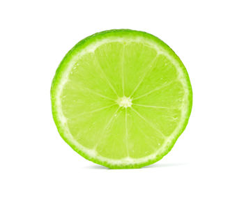 Close-up of lemon slice against white background