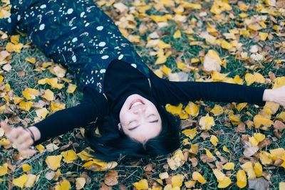 High angle view of woman lying on leaves