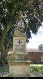 Low angle view of statue against trees