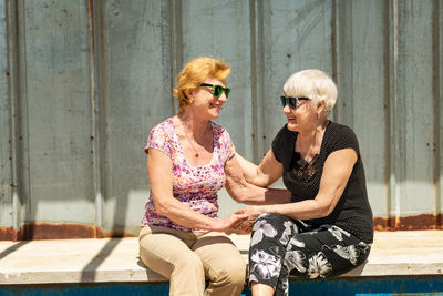 Two elderly women are happy to meet each other