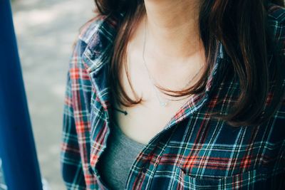 Midsection of woman wearing necklace