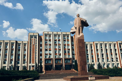 Low angle view of building against cloudy sky