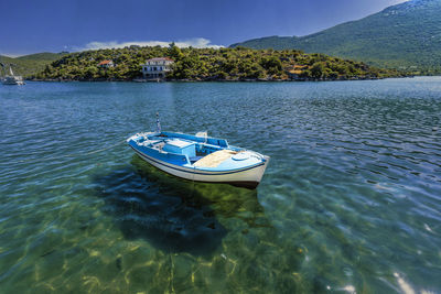 High angle view of boat moored on lake against sky