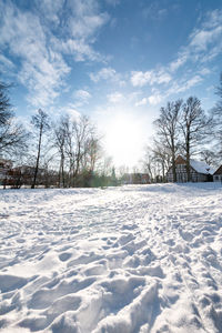 Snow covered field against sky